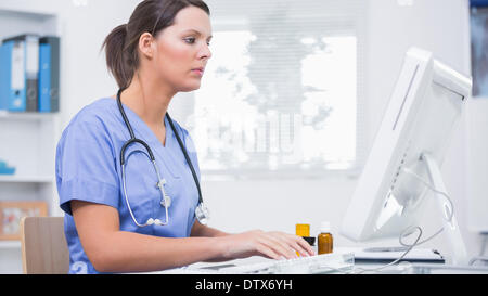 Female surgeon using computer at clinic Stock Photo