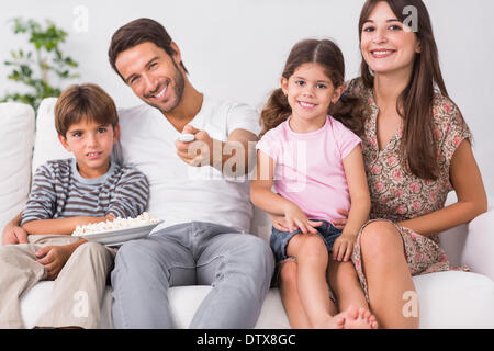 Happy family watching television together Stock Photo