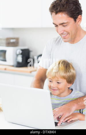 Father and son using laptop Stock Photo