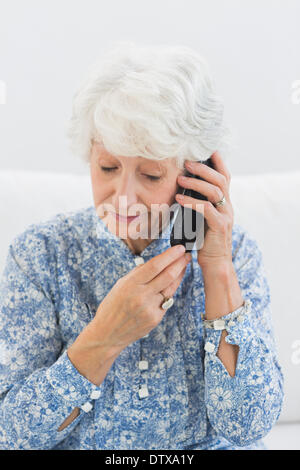 Aged woman phoning Stock Photo