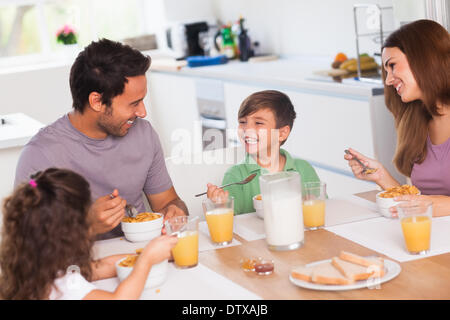 Family laughing around breakfast Stock Photo