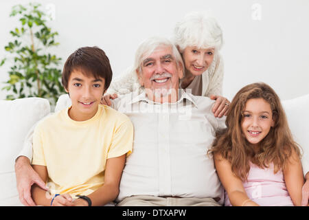 Grandparents with grandchildren on the sofa Stock Photo