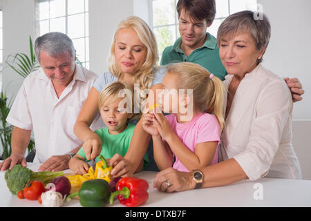 Mother chopping peppers for family Stock Photo