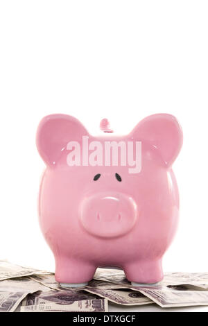 Close up of a pink piggy bank on dollars Stock Photo