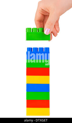 Hand and toy tower Stock Photo