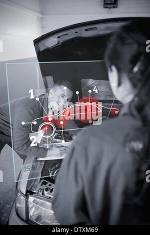 Two mechanics looking at futuristic interface Stock Photo