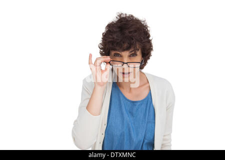 Shocked woman looking over her glasses Stock Photo