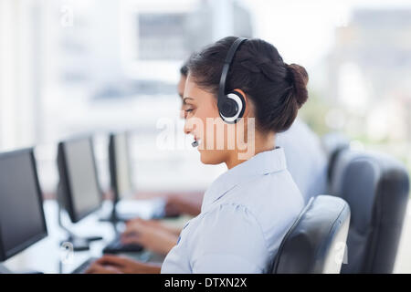 Attractive brunette working in a call centre Stock Photo