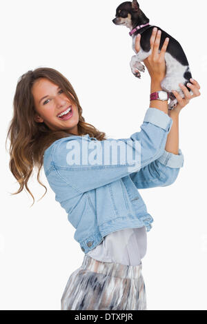 Happy woman lifting her chihuahua Stock Photo