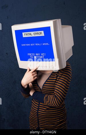 Person with a monitor head and fatal error blue screen on the display Stock Photo