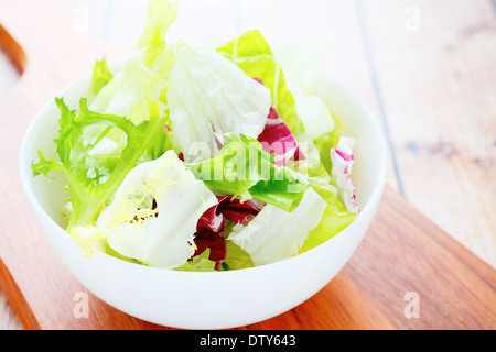 lettuce for salad in a white bowl, food closeup Stock Photo