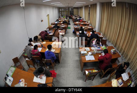 Changsha, China's Hunan Province. 24th Feb, 2014. Students study in the library of Hunan Normal University in Changsha, capital of central China's Hunan Province, Feb. 24, 2014. The library provides three rooms for students who prepare to take postgraduate examinations. The seats of the rooms are distributed to colleges based on their needs. Students can get a seat through seat card lottery or sharing a seat with others. The new way of seat assignment saves students' time and reduces the uncouth behavior. © Li Ga/Xinhua/Alamy Live News Stock Photo