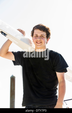 Mixed race boy carrying scull outdoors Stock Photo