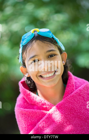 Mixed race girl wrapped in towel Stock Photo