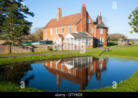 Traditional red brick farmhouse and farmyard water pond, Lux Farm, Kesgrave, Suffolk, England Stock Photo