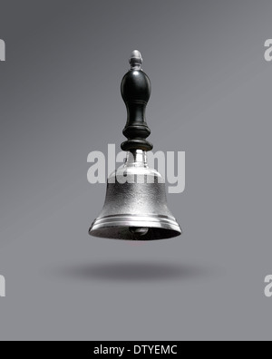 Hand bell floating on Grey with holding shadow Stock Photo