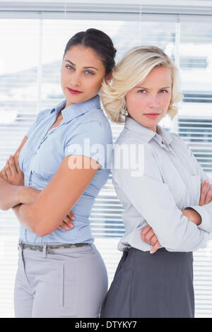 Serious businesswomen with arms folded Stock Photo