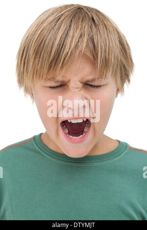Furious little boy shouting with eyes closed Stock Photo