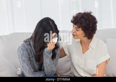 Patient crying next to her therapist Stock Photo