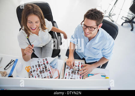 Cheerful photo editors working on a computer Stock Photo