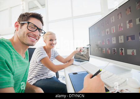 Cheerful photo editors working on photograph Stock Photo