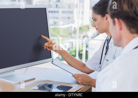 Doctor pointing at the screen of a computer Stock Photo