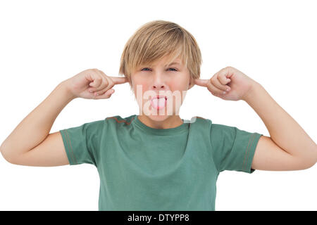 Blonde boy blocking his ears with fingers Stock Photo