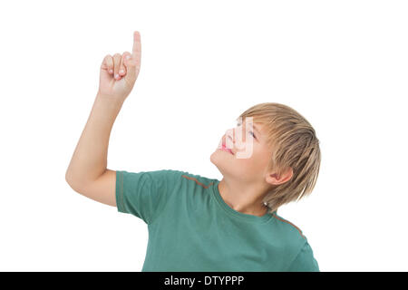 Boy raising his finger and looking up Stock Photo