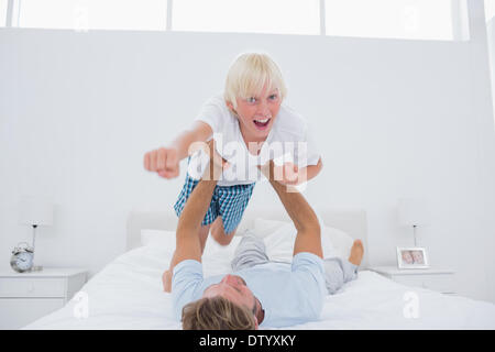 Father playing airplane holding his son Stock Photo