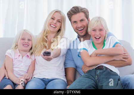 Happy family sitting on couch Stock Photo