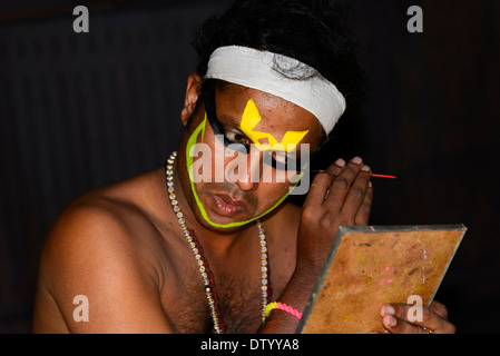 Kathakali dancer applying makeup in preparation for his performance, Kochi, Kerala, South India, India Stock Photo