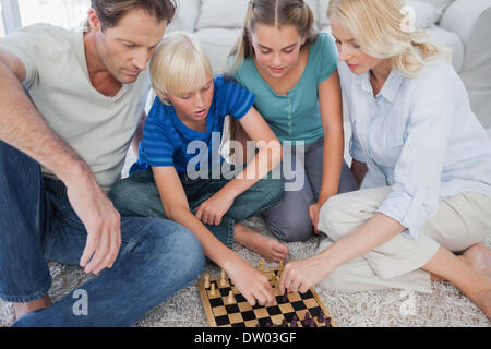 Portrait of a cute family playing chess Stock Photo