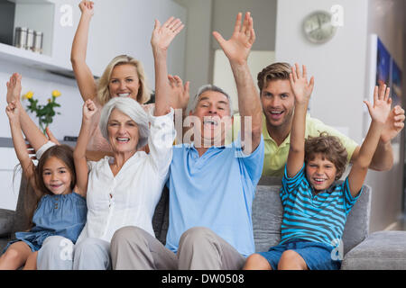 Multi-generation family raising their arms Stock Photo