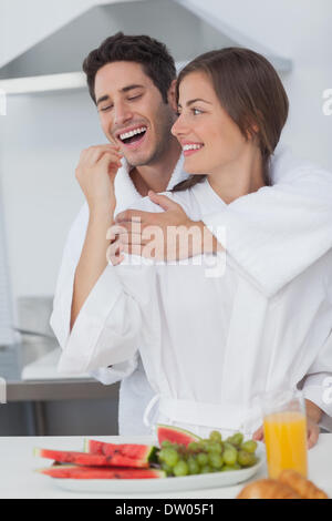 Woman giving a grape to her husband Stock Photo