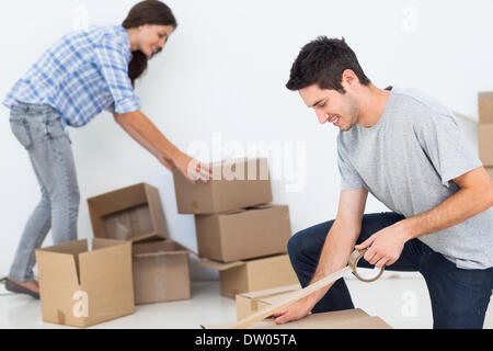 Woman and man wrapping boxes Stock Photo