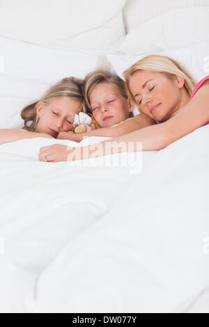 Woman sleeping in bed with her children Stock Photo