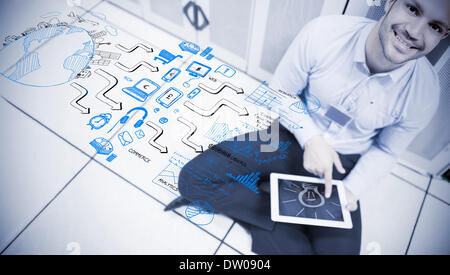Man sitting and using a tablet Stock Photo