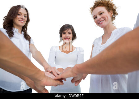 Cheerful models joining hands in a circle Stock Photo