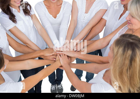 Female models joining hands in a circle Stock Photo