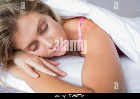 Peaceful blonde lying on her bed asleep Stock Photo