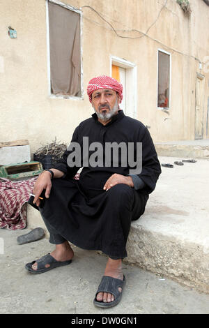 Feb. 21, 2014 - Al-Kitteh, Jarash, Jordan - Ahmad Mansour, 54, poses for a picture at his house in the village of al-Kitteh western city of Jerash, 50 km northern the Jordanian capital Amman on February 21, 2014 . Mansour arrived on foot on a stretcher as a Syrian refugee to Jordan one year ago after he was wounded in his left hand and his back by a mortar shell landed on his house in Daraa, followed by his wife and his twelve children after three months (Credit Image: © Ahmad Abdo/APA Images/ZUMAPRESS.com) Stock Photo