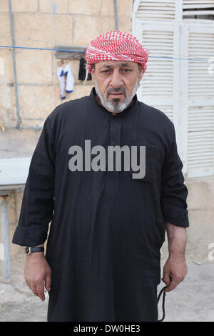 Feb. 21, 2014 - Al-Kitteh, Jarash, Jordan - Ahmad Mansour, 54, poses for a picture at his house in the village of al-Kitteh western city of Jerash, 50 km northern the Jordanian capital Amman on February 21, 2014 . Mansour arrived on foot on a stretcher as a Syrian refugee to Jordan one year ago after he was wounded in his left hand and his back by a mortar shell landed on his house in Daraa, followed by his wife and his twelve children after three months (Credit Image: © Ahmad Abdo/APA Images/ZUMAPRESS.com) Stock Photo