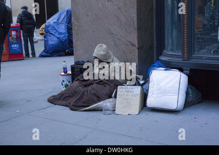 Homeless man begging along 5th Avenue in Manhattan, NYC. Stock Photo