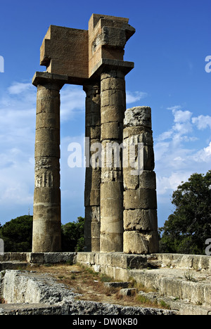 Remains of ancient Greek temple, few stone columns, at sunny summer day. Stock Photo