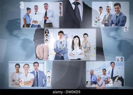 Businessman presenting pictures of coworkers Stock Photo
