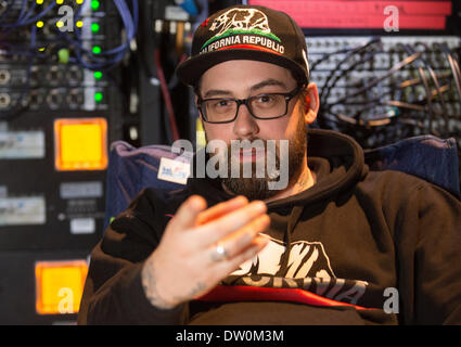 Rostock, Germany. 25th Feb, 2014. Rapper Sido sits behind the stage before his performance in Rostock, Germany, 25 February 2014. Sido starts his Germany tour which will continue until 2015 in Rostock. Photo: Axel Heimken/dpa/Alamy Live News Stock Photo