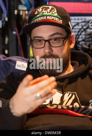 Rostock, Germany. 25th Feb, 2014. Rapper Sido sits behind the stage before his performance in Rostock, Germany, 25 February 2014. Sido starts his Germany tour which will continue until 2015 in Rostock. Photo: Axel Heimken/dpa/Alamy Live News Stock Photo