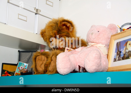 Teddies on shelf in child's room Stock Photo