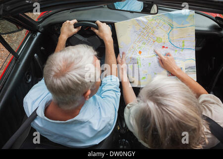 Overhead view of mature couple reading map Stock Photo