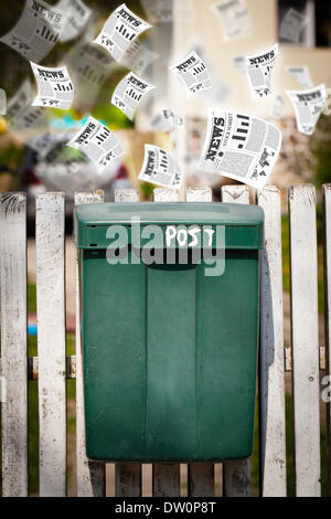 Post box with daily newspapers flying Stock Photo